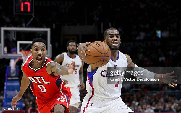 Chris Paul of the Los Angeles Clippers controls the ball before Jeff Teague of the Atlanta Hawks can get a hand on the ball in the first half during...