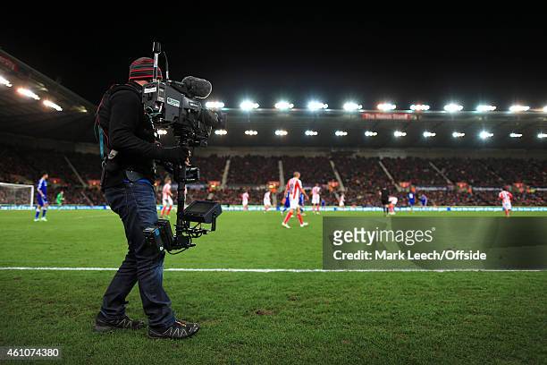 Steadicam television cameraman works on the sidelines during the Barclays Premier League match between Stoke City and Chelsea at the Britannia...