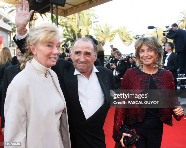 French actor Claude Brasseur and his wife Michele Cambon-Brasseur arrive with producer Daniele Thompson at the Festival Palace to attend the premiere...