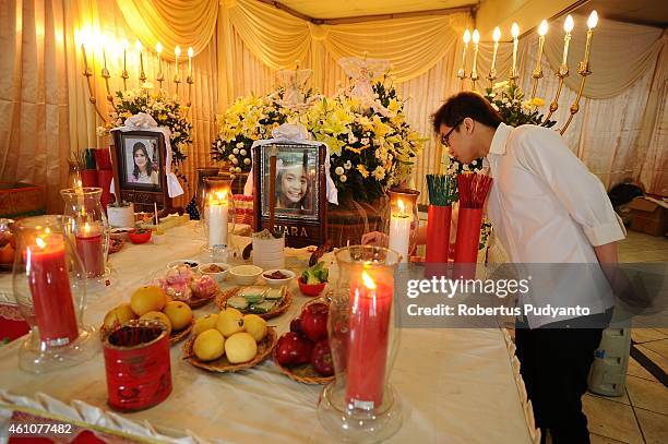 The remains of The Meiji Tejakusuma and her daughter Jie Stevie Gunawan, victims of the AirAsia flight QZ8501 disaster, are laid out at Adi Yasa...