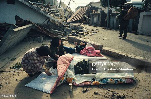 Women shed tears as a body of their family is recovered from the debris on January 17, 1995 in Ashiya, Hyogo, Japan. Magnitude 7.3 strong earthquake...