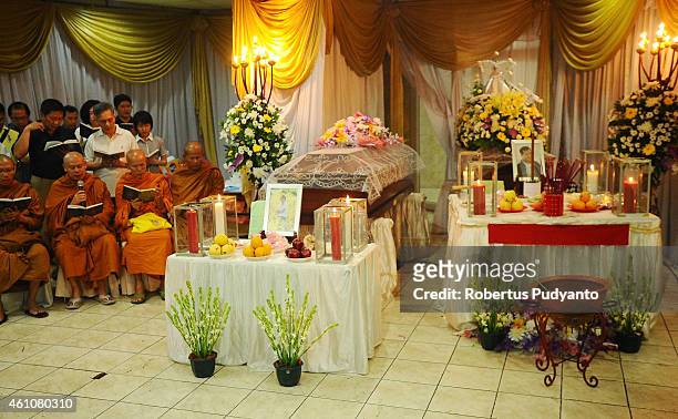 Buddhist monks lead a prayer for Brian Youvito Jou and Yongki Jou , victims of the AirAsia flight QZ8501 disaster at Adi Yasa funeral house on...