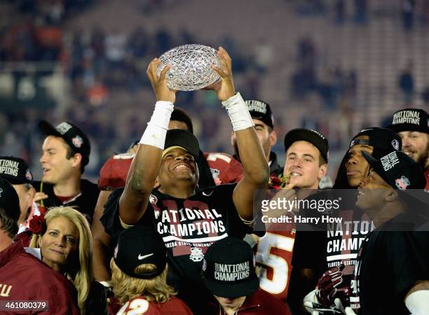 Quarterback Jameis Winston of the Florida State Seminoles holds the Coaches' Trophy after defeating the Auburn Tigers 34-31 in the 2014 Vizio BCS...