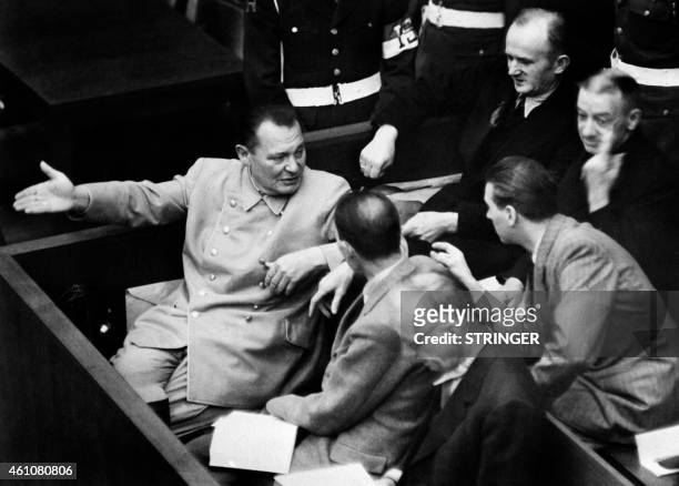 Photo taken during 1946 at the Nuremberg International Military Tribunal court shows former President of the Reichstag Hermann Goering speaking with...