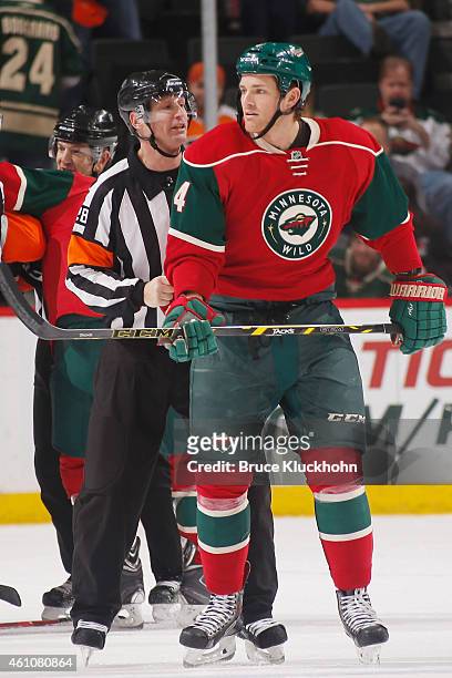 Stu Bickel of the Minnesota Wild is pulled aside by an official during the game against the Philadelphia Flyers on December 23, 2014 at the Xcel...