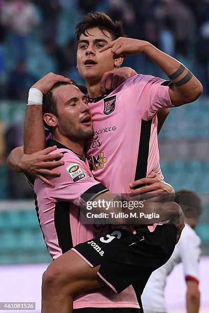 Paulo Dybala of Palermo celebrates with Franco Vazquez after scoring his team's fourth goal during the Serie A match between US Citta di Palermo and...