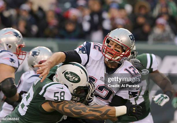 Quarterback Tom Brady of the New England Patriots is Intercepted when hit by Linebacker Jason Babin of the New York Jets at MetLife Stadium on...