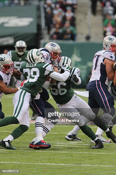 Quarterback Tom Brady of the New England Patriots is Sacked by Linebacker Demario Davis and Safety Antionio ALlen of the New York Jets at MetLife...