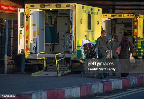 Patient is wheeled from a ambulance parked outside the Accident and Emergency department of Gloucestershire Royal Hospital on January 6, 2015 in...