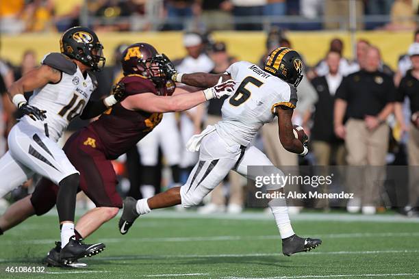 Marcus Murphy of the Missouri Tigers runs the football for a touchdown that was nullified by a penalty during the Buffalo Wild Wings Citrus Bowl...