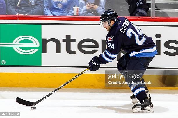 Grant Clitsome of the Winnipeg Jets plays the puck up the ice during second period action against the Minnesota Wild on December 29, 2014 at the MTS...