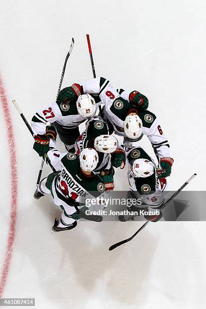 Brett Sutter, Marco Scandella, Justin Fontaine, Kyle Brodziak and Jared Spurgeon of the Minnesota Wild celebrate a second period goal against the...