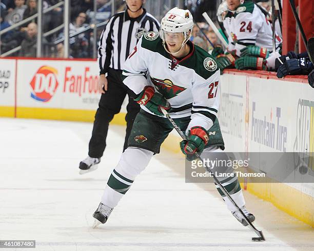 Brett Sutter of the Minnesota Wild plays the puck up the ice during third period action against the Winnipeg Jets on December 29, 2014 at the MTS...