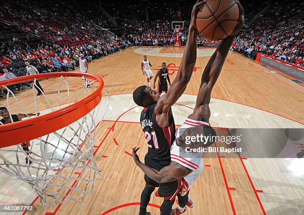 Hassan Whiteside of the Miami Heat blocks a shot against Joey Dorsey of the Houston Rockets during the game on January 3, 2015 at the Toyota Center...