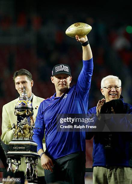 Head coach Bryan Harsin of the Boise State Broncos holds up the Fiesta Bowl trophy after the team's 38-30 victory over the Arizona Wildcats in the...