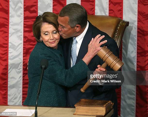 House Minority Leader Nancy Pelosi hands Speaker of the House John Boehner the speaker's gavel during the first session of the 114th Congress in the...