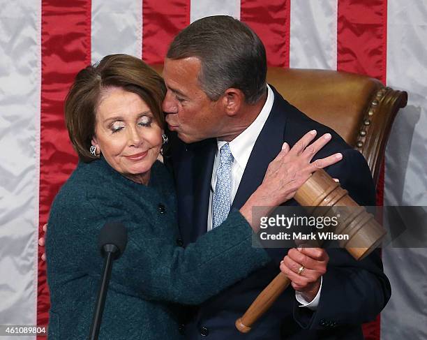 House Minority Leader Nancy Pelosi is kissed by Speaker of the House John Boehner as he is handed the speaker's gavel during the first session of the...