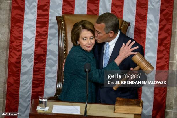 House Minority Leader Nancy Pelosi, D-CA, is kissed as she hands over the gavel to Speaker of the House John Boehner, R-OH, during a swearing-in...