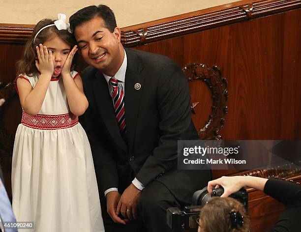 Rep. Carlos Curbelo poses for a picture with his daughter Sylvie while she makes a funny face during the first session of the 114th Congress in the...