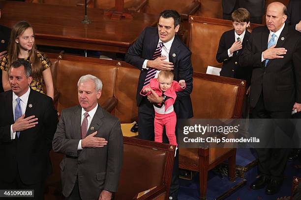 Rep. Kevin Yoder holds his daughter Caroline Lucille Yoder while reciting the Pledge of Allegiance during the opening session of the 114th Congress...