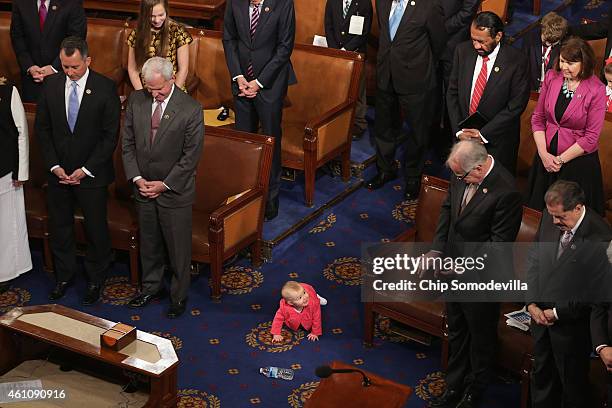 Caroline Lucille Yoder , daughter of Rep. Kevin Yoder , crawls on the floor of the U.S. House of Represenatatives during the opening prayer of the...