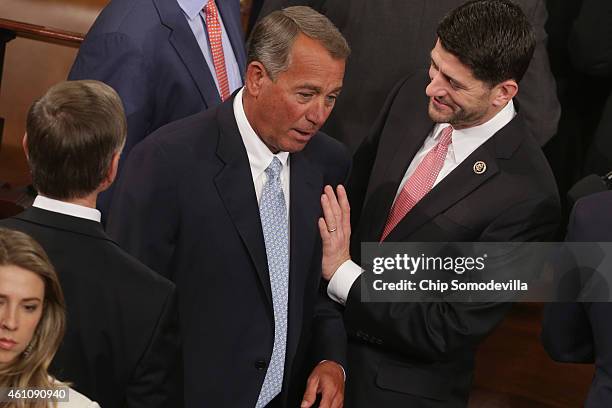 Speaker of the House John Boehner talks with Rep. Paul Ryan during the opening session of the 114th Congress in the House of Representatives chamber...