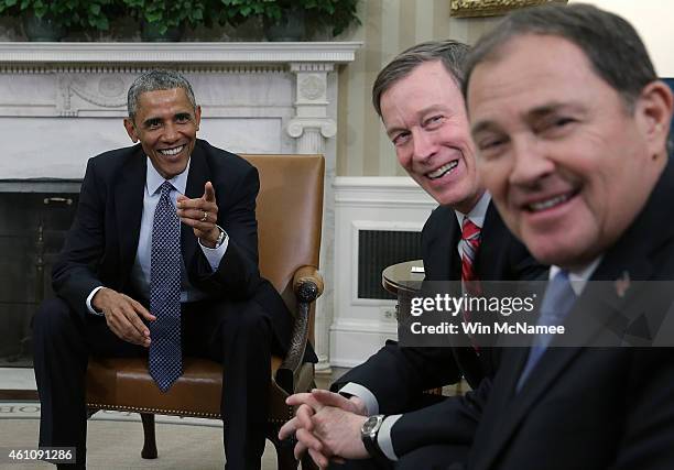 President Barack Obama jokes with National Governors Association Chairman Gov. John Hickenlooper and Vice Chairman Gov. Gary Herbert in the Oval...