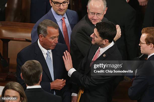 Speaker of the House John Boehner talks with Rep. Paul Ryan during the opening session of the 114th Congress in the House of Representatives chamber...