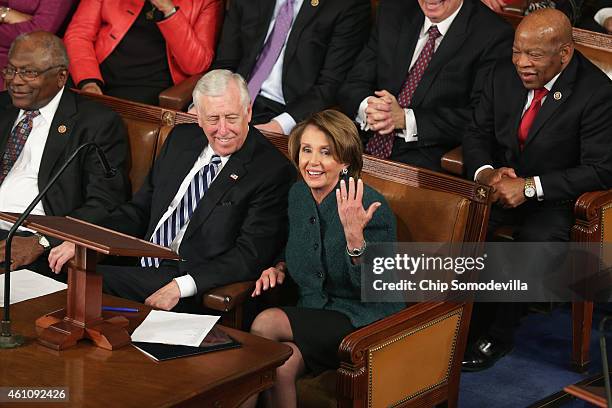 House Minority Leader Nancy Pelosi acknowledges her supporters and fellow Democrats during the opening session of the 114th Congress with Rep. James...