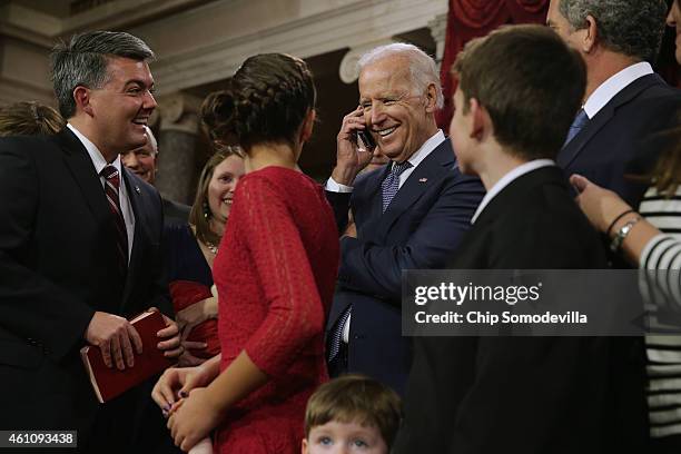 Sen. Cory Gardner watches as Vice President Joe Biden talks to Gardner's grandmother, Betty Pagel of Yuma, Colorado, on the phone after his...