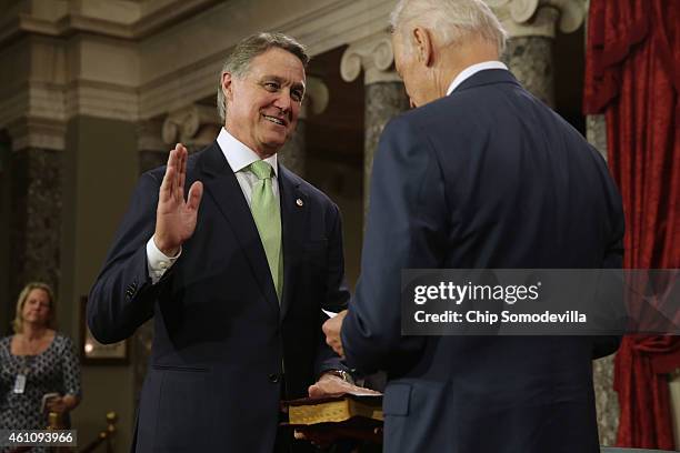 Sen. David Perdue is ceremonially sworn in by Vice President Joe Biden in the Old Senate Chamber at the U.S. Capitol January 6, 2015 in Washington,...