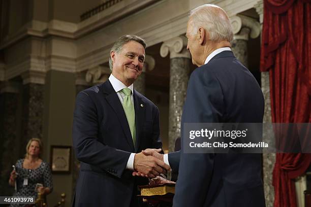 Sen. David Perdue is congratulated by Vice President Joe Biden during a ceremonial searing in ceremony in the Old Senate Chamber at the U.S. Capitol...