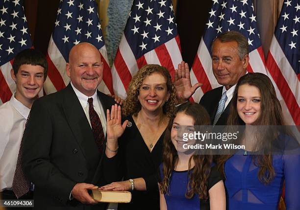 Speaker of the House John Boehner poses with Rep. Debbie Wasserman Schultz and her family during a ceremonial swearing in at the US Capitol January...