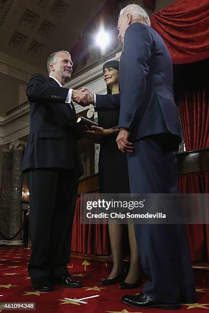 Sen. Dan Sullivan is congratulated by U.S. Vice President Joe Biden during a cermonial swearing-in in the Old Senate Chamber with Sullivan's wife...