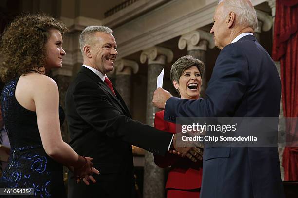 Vice President Joe Biden congratulates Sen. Joni Earnst and her family, daughter Libby Ernst and husband Gail Ernst, during a cermonial swearing-in...