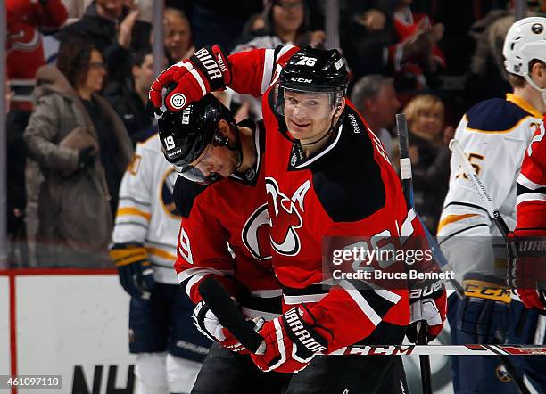 Patrik Elias congratulates Travis Zajac of the New Jersey Devils on his first period shorthanded goal against the Buffalo Sabres at the Prudential...