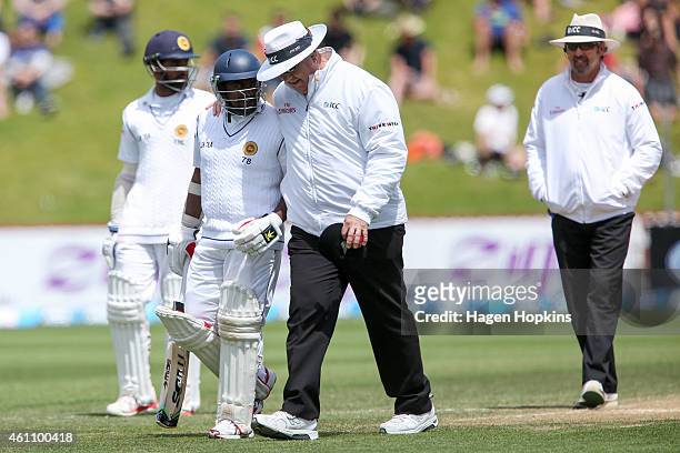 Rangana Herath of Sri Lanka talks to umpire Steve Davis of Australia after being dismissed during day five of the Second Test match between New...