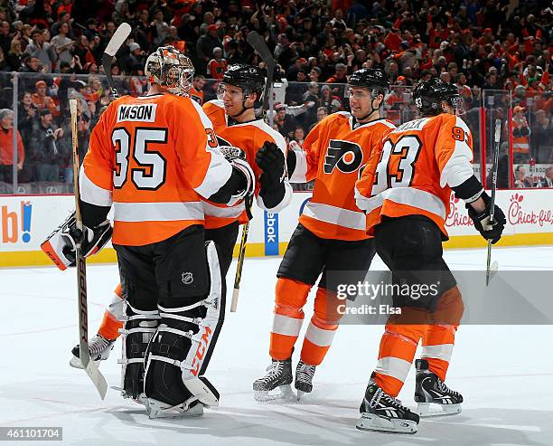 Steve Mason of the Philadelphia Flyers is congratulated by teammates Brayden Schenn,Chris Vande Velde and Jakub Voracek after the overtime shootout...