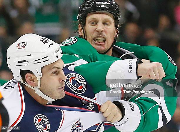 Travis Moen of the Dallas Stars takes a swing at Jared Boll of the Columbus Blue Jackets in the second period at American Airlines Center on January...
