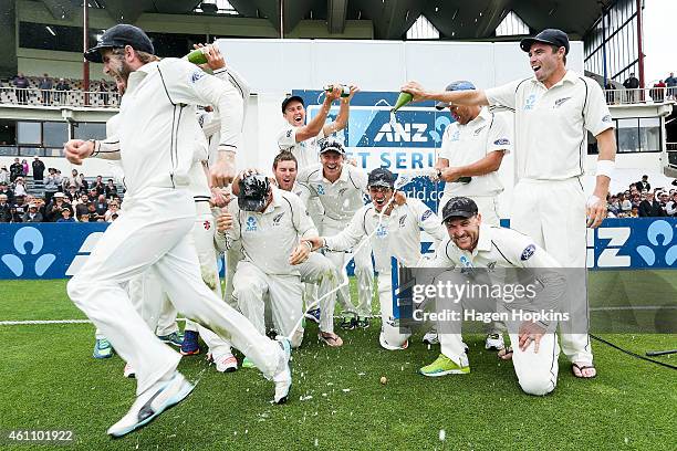 Kane Williamson escapes a dousing of champagne as New Zealand celebrate their ANZ Test Series win during day five of the Second Test match between...