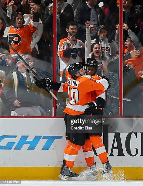 Brayden Schenn congratulates Wayne Simmonds of the Philadelphia Flyers after Simmonds scored a goal in the third period against the Ottawa Senators...