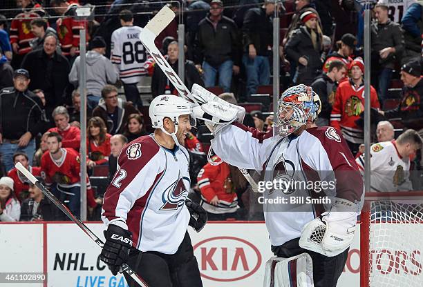 Goalie Semyon Varlamov and Jarome Iginla of the Colorado Avalanche celebrate after Varlamov shut out the Chicago Blackhawks 2-0 during the NHL game...