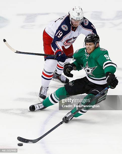 Tyler Seguin of the Dallas Stars is checked by Ryan Johansen of the Columbus Blue Jackets in the third period at American Airlines Center on January...