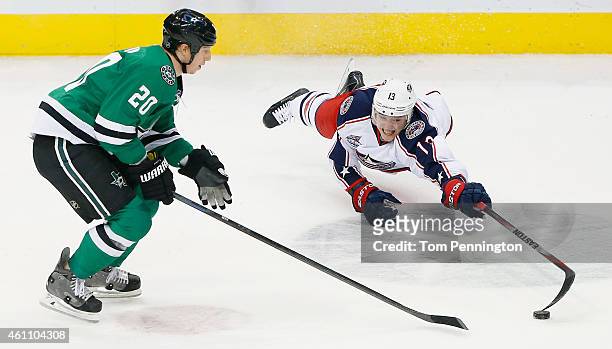 Cam Atkinson of the Columbus Blue Jackets dives for control of the puck against Cody Eakin of the Dallas Stars in the third period at American...