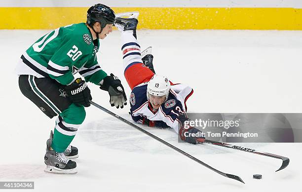 Cam Atkinson of the Columbus Blue Jackets dives for control of the puck against Cody Eakin of the Dallas Stars in the third period at American...