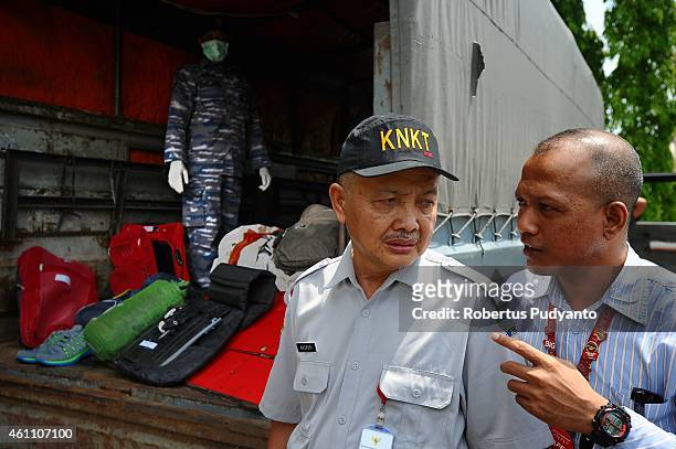 Indonesia National Transportation Safety Committee officer, Masruri observes parts of aircraft AirAsia flight QZ8501 during a handover ceremony from...