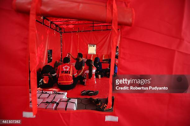 Indonesian Red Cross personnel rest during a break on the 11th day of the AirAsia flight QZ8501 disaster on January 7, 2015 in Surabaya, Indonesia. A...