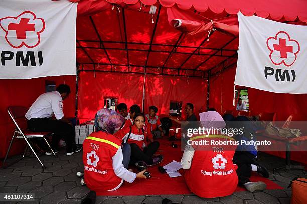 Indonesian Red Cross personnel rest during a break on the 11th day of the AirAsia flight QZ8501 disaster on January 7, 2015 in Surabaya, Indonesia. A...