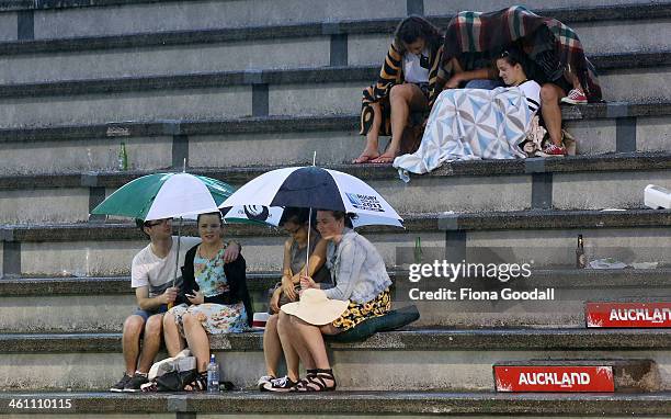 Spectators brave the rain after the match between Bradley Klahn of USA and Daniel Brands of Germany was called off in the second set due to rain. The...