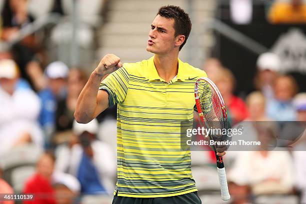 Bernard Tomic of Australia celebrates victory in his first round match against Marcel Granollers of Spain during day three of the 2014 Sydney...